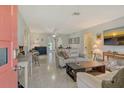 Bright living room with modern decor, neutral tones, stylish furnishings and terrazzo flooring throughout at 314 28Th W St, Bradenton, FL 34205