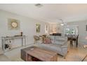 Open living area with neutral-toned decor, comfortable seating, and terrazzo flooring throughout at 314 28Th W St, Bradenton, FL 34205