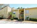 Condo building with exterior stairs, lush landscaping, and a well-maintained facade at 3403 Clark Rd # 203, Sarasota, FL 34231