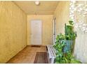 Condo entryway featuring tile flooring, white door, and space for seating at 3403 Clark Rd # 203, Sarasota, FL 34231