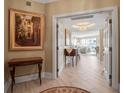 Foyer with detailed chandelier and decor leading into the living room at 3621 North Point Rd # 603, Osprey, FL 34229