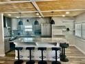 Modern kitchen boasts a large island with bar seating, stainless steel appliances, and stylish pendant lighting at 3710 Gulf Of Mexico Dr # E22, Longboat Key, FL 34228