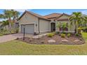 Charming single-story home boasts lush landscaping, paver driveway, and tile roof at 3921 Waypoint Ave, Osprey, FL 34229