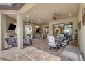 This outdoor space is perfect for entertaining, offering a kitchen, bar, and outdoor seating area with ceiling fans at 3921 Waypoint Ave, Osprey, FL 34229