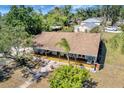 Aerial view showcasing the home's large, covered front porch, mature trees, and manicured yard at 4030 Worcester Rd, Sarasota, FL 34231