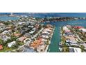 Aerial view of waterfront neighborhood and stunning home with pool and barrel tile roof at 465 E Royal Flamingo Dr, Sarasota, FL 34236