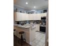 Well-lit kitchen features granite countertops and stainless steel appliances at 4707 1St E Ave # 4707, Palmetto, FL 34221