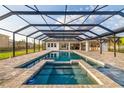 Relaxing pool area with covered screened-in lanai featuring brick pavers and a gorgeous tile surround at 4712 Margutta Ct, Sarasota, FL 34240