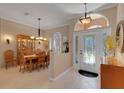 Inviting foyer leads to a dining area, showcasing a blend of tile and wood flooring at 4926 Sabal Lake Cir, Sarasota, FL 34238