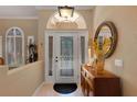 Bright foyer with an arched window above the door and tile flooring at 4926 Sabal Lake Cir, Sarasota, FL 34238