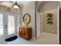 Welcoming foyer featuring a decorative mirror, console table, and tile flooring at 4926 Sabal Lake Cir, Sarasota, FL 34238