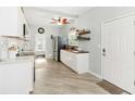 Bright kitchen features white cabinets, stainless steel appliances, and stylish decor elements at 516 45Th Street W Ct, Palmetto, FL 34221