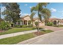 Beautiful home with a red tile roof, three-car garage, and manicured landscaping at 5412 Royal Poinciana Way, North Port, FL 34291