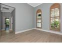 Sunlit bedroom with hardwood floors, wood shuttered windows and crown molding at 600 Eagle Watch Ln, Osprey, FL 34229