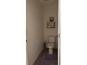 Clean bathroom with toilet, wall shelving, and tiled floor at 615 Sunlit Coral St, Ruskin, FL 33570