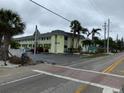 Charming condominium complex with lush landscaping, featuring a sign out front at 6703 Midnight Pass Rd # 206, Sarasota, FL 34242