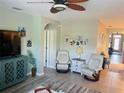 Bright and airy living area with tile flooring, comfortable seating, and stylish decor, creating a welcoming space at 7508 Mikasa Dr, Punta Gorda, FL 33950