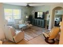 Cozy living room with comfortable seating, a ceiling fan, and plenty of natural light, creating a relaxing atmosphere at 7508 Mikasa Dr, Punta Gorda, FL 33950