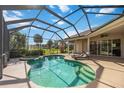 Relax in the sun in a beautiful screened-in lanai and pool with a built-in hot tub at 7581 Camden Harbour Dr, Bradenton, FL 34212
