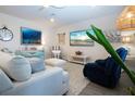 Comfortable living room featuring a plush sofa, artwork, and stylish coastal-themed decor at 8232 Reefbay Cv, Parrish, FL 34219