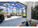 Relaxing screened patio with comfortable seating and serene lake views, perfect for outdoor enjoyment at 8232 Reefbay Cv, Parrish, FL 34219
