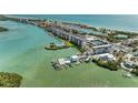 Aerial view of waterfront condos, marina, pool and tennis courts at 8977 Midnight Pass Rd # 519, Sarasota, FL 34242