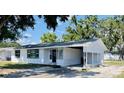 Charming single-story home with a carport, white siding, and black trim around the windows at 1028 36Th E Ave, Ellenton, FL 34222