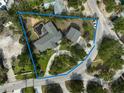 Aerial view of a property that has a pool with the property line in blue at 105 Island Cir, Sarasota, FL 34242