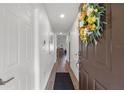 Inviting entryway with light wood flooring and fresh decor, leading to the home's interior at 18106 Canal Pointe St, Tampa, FL 33647