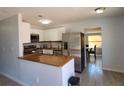 Modern kitchen featuring stainless steel appliances, a breakfast bar, and tile flooring at 2035 Vinson Ave, Sarasota, FL 34232