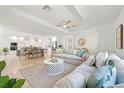 Bright and airy living room with open floor plan, modern furnishings, and seamless flow to dining area at 204 75Th St, Holmes Beach, FL 34217
