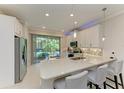 Bright, modern kitchen with stainless steel appliances, quartz countertops, and bar stool seating at 224 Soliera St, Nokomis, FL 34275