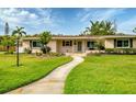 Charming single-story home with manicured lawn and walkway leading to the front door at 3072 Meyer Dr, Sarasota, FL 34239