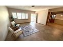 Bright living room with tile flooring, neutral paint, shuttered window, and an open doorway at 3072 Meyer Dr, Sarasota, FL 34239