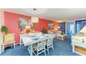 Open living room, nicely decorated with coral accent wall at 3562 Lake Bayshore Dr # 202, Bradenton, FL 34205
