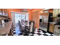 Bright dining room with checkered floors, stainless steel refrigerator and sliding glass doors at 3915 40Th W St, Bradenton, FL 34205