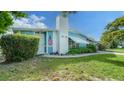 Charming single-story home with well-maintained lawn, mature trees and a welcoming front door at 4015 52Nd Street W Ct, Bradenton, FL 34209