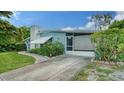 Charming single-story home with well-maintained lawn, mature trees and a long concrete driveway at 4015 52Nd Street W Ct, Bradenton, FL 34209