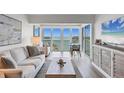 Cozy living room with water views, and light colored contemporary furniture at 4310 Falmouth Dr # 305, Longboat Key, FL 34228