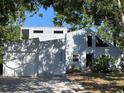 Modern architectural home design with a garage and mature landscaping at 4639 Sloan Ave, Sarasota, FL 34233