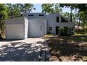 View of the front exterior showing architectural details and mature landscaping at 4639 Sloan Ave, Sarasota, FL 34233