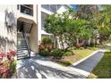 Apartment exterior with stairwell, outdoor balcony, and landscaped grounds at 5122 Northridge Rd # 112, Sarasota, FL 34238