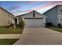 Charming single-Gathering home featuring a well-manicured lawn and a two-car garage at 5547 Logan Cave Ave, Wimauma, FL 33598