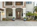 Inviting front entrance with elegant stone accents and a decorative front door at 5609 Arnie Loop, Lakewood Ranch, FL 34211