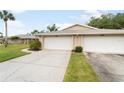 View of the home's driveway, complemented by lush green lawns at 5689 Evergreen Dr # 18, Sarasota, FL 34233