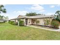 Charming single-story home featuring a well-maintained lawn and landscaping at 5689 Evergreen Dr # 18, Sarasota, FL 34233