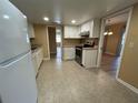 Functional kitchen featuring white cabinets and tile flooring at 6912 10Th W Ave, Bradenton, FL 34209