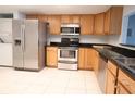 A well-equipped kitchen featuring stainless steel appliances and tile flooring at 7500 40Th W Ave # 209, Bradenton, FL 34209