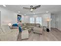 Bright living room featuring modern furniture, a ceiling fan, and recessed lighting at 8152 Seashell St, Englewood, FL 34224