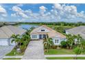Stunning aerial view of single-Gathering home showing lush landscaping, and beautiful lake views at 8258 Grande Shores Dr, Sarasota, FL 34240